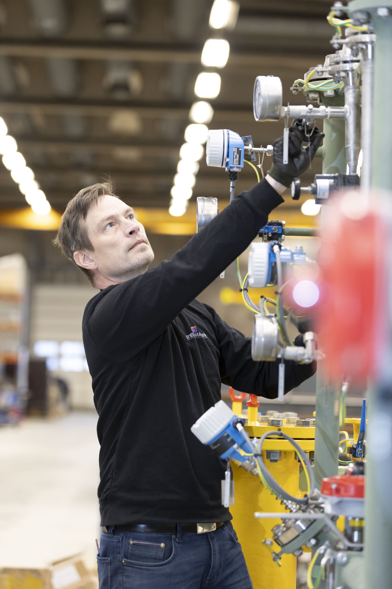 Steel Master mechanic inspecting machine